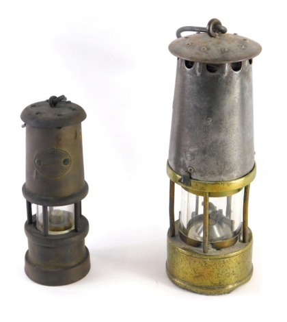 A 20thC brass miner's lamp, of cylindrical form with metal fittings, 25cm high, and a further smaller Lamp And Limelight Colliery miner's lamp. (2)