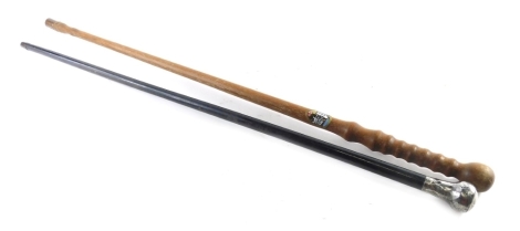 An ebonised walking cane, with silver knop and a turned wooden walking stick, 86cm high.