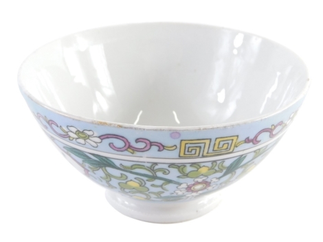 A Russian Gardner Chinese design bowl, profusely decorated with panels of vases and flowers broken by further flowers on a blue ground with a Greek key and floral border on circular foot, marked beneath, 13cm diameter. Ex-Fulbeck Hall collection.