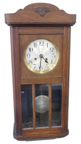 A 20thC oak wall clock, with 17cm diameter Arabic dial in a glazed case with eight day movement, 71cm high.