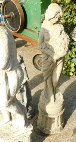 A modern concrete garden statue, formed as a classical lady holding flowers, on a shaped socle base, 106cm high.