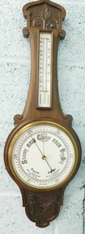 An early 20thC oak cased thermometer and barometer, with 19cm diameter dial, heavily carved case set with fleur de lys and scroll, 75cm high.