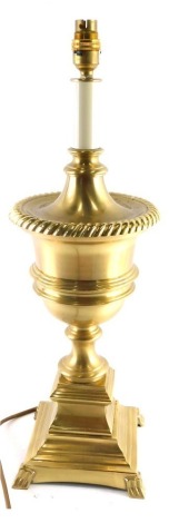 A 20thC brass urn table lamp, on inverted stem with square base terminating in stylised paw feet, 59cm high.