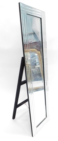 A retro floor standing mirror, with plain glass and distorted glass surround, with easel back, 152cm high, 39cm wide.