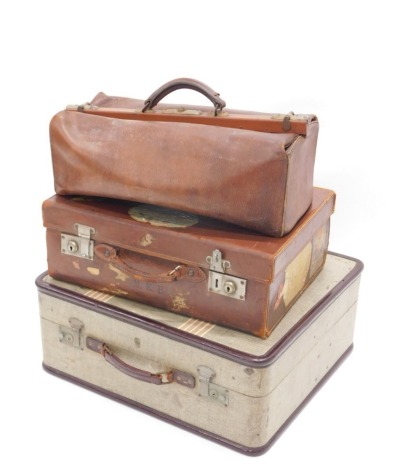 An early 20thC pressed brown leather travel case, with chrome lock, plain interior with some luggage labels to the lid, 19cm high, 48cm wide, 35cm deep, a further case and a Gladstone bag. (3)