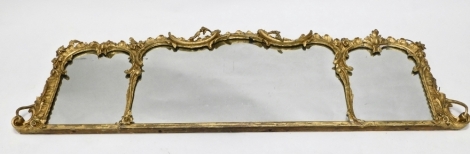 A 19thC gilt wood overmantel mirror, in serpentine frame, the central glass flanked by two further mirrors, with scroll and floral moulding to the elaborate border, 39cm high, 160cm wide, 5cm deep.