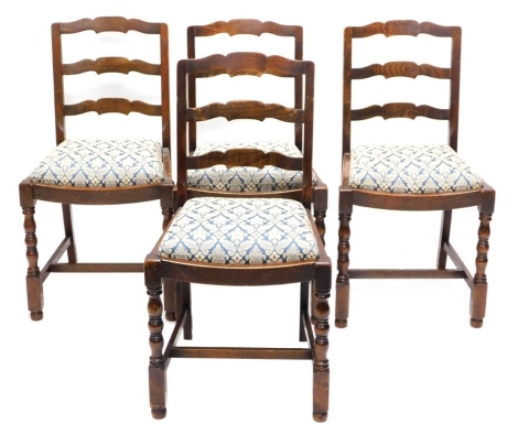 A set of four oak ladderback chairs, each with a drop in seat, on part turned legs.