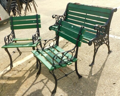 A three piece garden furniture suite, comprising small bench with metal ends and slatted back and seat, and two matching chairs, the bench 98cm wide.