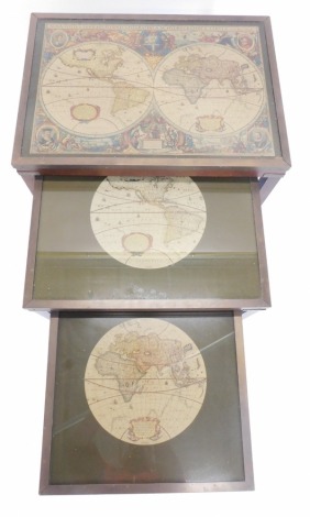 A nest of three mahogany tables, each inset with a map of the world, within brass borders, the largest 63cm wide.