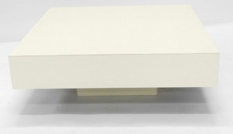 A modern cream Perspex square coffee table, on a rectangular plinth, 28cm high, 80cm wide.