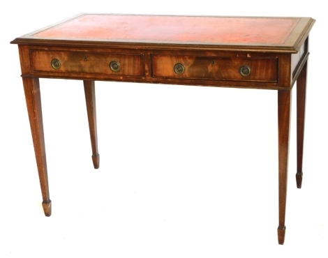 A mahogany writing table, the rectangular top with a red leather insert, above two frieze drawers, on square tapering legs, 107cm wide.