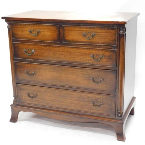 A mahogany chest of drawers, in the George III style, the top with a crossbanded border, above two short and three long drawers flanked by part turned pilasters, on splayed feet, 80cm high, 87cm wide, 47cm deep.