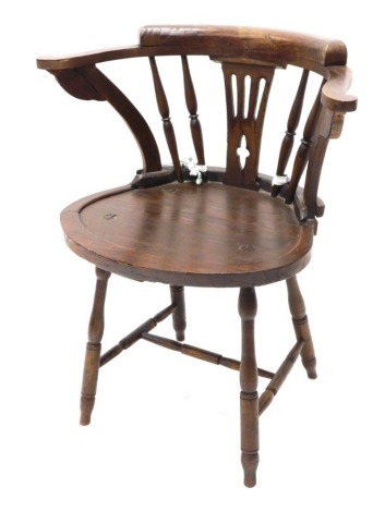 A late 19thC/early 20thC stained oak country made open armchair, with a curved back, pierced splat and a solid seat, on turned legs with H stretcher.