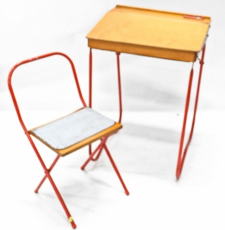 A Triang type child's desk, with hinged sloped top and red metal tubular frame and a matching chair. 80cm wide. (2)