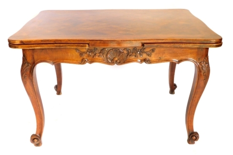 A continental walnut draw leaf dining table, with a marquetry shaped top, on leaf carved cabriole legs, 73cm high, 206cm wide, 89cm deep extended.