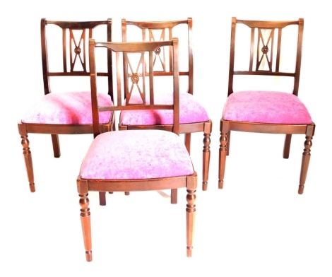 A set of four Stag Minstrel mahogany dining chairs, each with a purple drop in seat on turned legs. The upholstery in this lot does not comply with the 1988 (Fire & Fire Furnishing) Regulations, unless sold to a known exporter or upholsterer it will be c