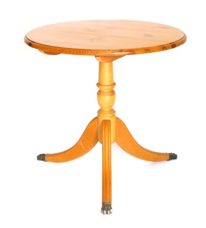 A pine occasional table, circular top with a moulded edge, on turned column and reeded splayed legs with castors, 75cm wide,.