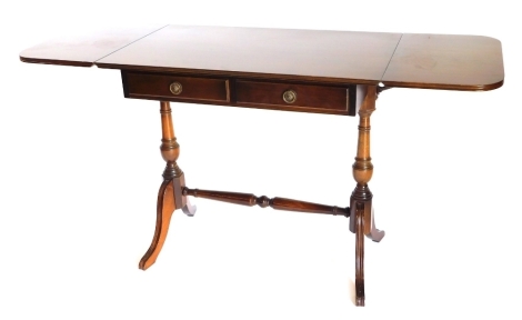 A mahogany sofa table, the top with rounded corners and a reeded edge, above two frieze drawers, on turned down supports with stretcher and sabre leg, 82cm wide.