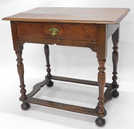 A 19thC oak side table, with a rectangular top with a moulded edge above a frieze drawer, on turned supports with shaped stretcher and bun feet, 70cm, high, 76cm wide, 49cm deep.