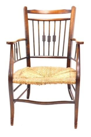 An Edwardian mahogany elbow chair of small proportion, with rope seat, serpentine stretcher and cabriole front legs, 93cm high.