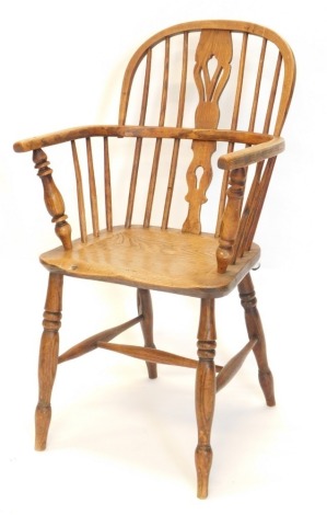 A 19thC ash and elm Windsor chair, with a pierced splat, turned supports and a solid seat, on turned tapering legs with H stretcher.