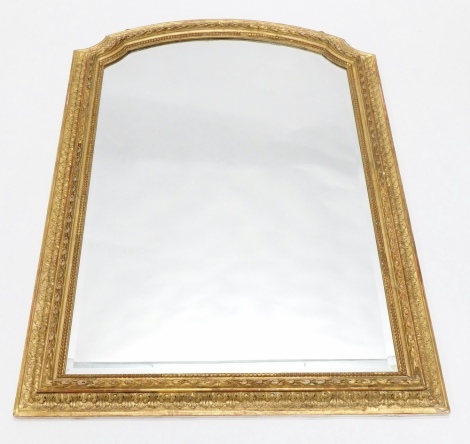 A 19thC gilt gesso overmantel mirror, with arched top, the framed decorated with leaves, beads and bell flower, surrounding a bevelled plate, 130cm high, 90cm wide.