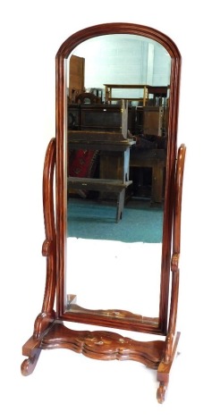 A Victorian mahogany cheval mirror, with an arched bevelled plate, a moulded frame and shaped supports with platform base, 73cm wide.