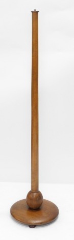 An Ercol type beech standard lamp, of turned form with bun feet, 140cm high.