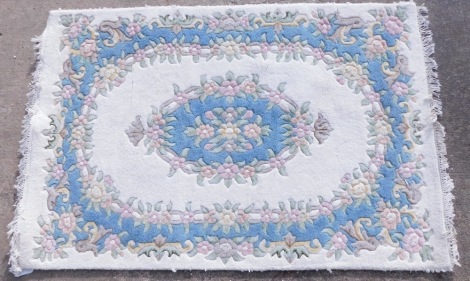 An Indian rug, with a floral design on a cream ground, 179cm x 121cm.