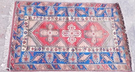 A Persian type rug, decorated with stars on a red ground with geometric spandrels, one wide, two narrow borders, 190cm x 119cm.