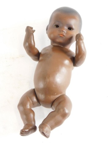 An Armand Marseille porcelain bisque headed baby doll with composition body, 24cm high.