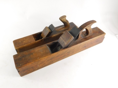 Two beech woodworking jack planes, one stamped R McIntyre, one stamped to the blade Marples, the other indistinct, 66cm long and 44cm long respectively.