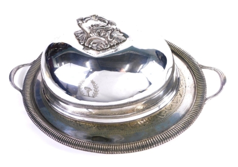 A silver plated meat cover, Savory family crest, with an elaborate scroll handle, marked Goldsmiths Alliance Cornhill London, and a similar 19thC silver plated tray with fluted exterior and shaped handles. (2)