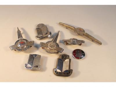 Four Morris car badges and four standard car badges