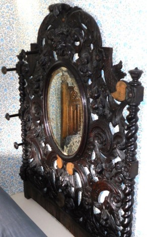 A 19thC carved oak hall mirror, with masks, fruit, scrolls, and barley twist supports, 153cm high, for display plus a backing slip of 15cm, 120cm wide. (AF)