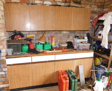 A range of Hygena cabinets and contents, being tools, sundries, etc. and contents of staging rack in the corner run of tools including jerry cans, axe, sprayer, rakes, etc. (a quantity)