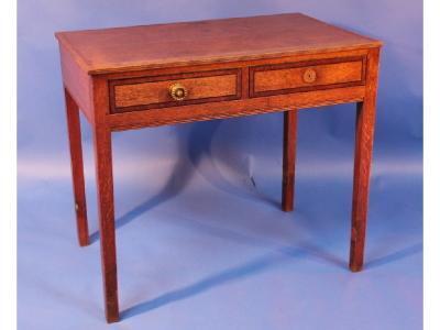 An early 19thC oak two drawer hall table on square tapering legs