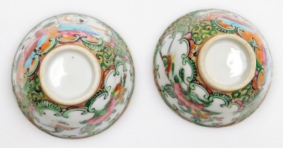 A 19thC Chinese Canton decorated cabaret part tea set, the shaped tray decorated with figures within scroll borders in pink, blue, and green, picked out in gilt, a teapot and two bowls, the tray 27cm diameter. - 15