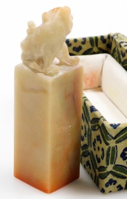 Two similar Chinese porcelain soapstone seals, each with a carved dog of fo finial, in fitted box, and a soapstone and silver coloured metal box and cover, 9cm wide, and a similar box with coloured glass cabochon. (4) - 11