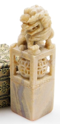 Two similar Chinese porcelain soapstone seals, each with a carved dog of fo finial, in fitted box, and a soapstone and silver coloured metal box and cover, 9cm wide, and a similar box with coloured glass cabochon. (4) - 13
