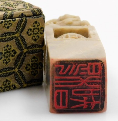 Two similar Chinese porcelain soapstone seals, each with a carved dog of fo finial, in fitted box, and a soapstone and silver coloured metal box and cover, 9cm wide, and a similar box with coloured glass cabochon. (4) - 15