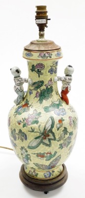 A Chinese porcelain vase, decorated with butterflies and flowers, against a mottled green ground with applied figures of children, on a hardwood base, converted into a table lamp, 51cm high overall. - 3