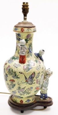 A Chinese porcelain vase, decorated with butterflies and flowers, against a mottled green ground with applied figures of children, on a hardwood base, converted into a table lamp, 51cm high overall. - 4