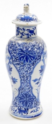 A 19thC Chinese porcelain baluster vase and cover, the lid with dog of fo finial, decorated in blue and white with reserves of a phoenix and a flowering branch, four character Kangxi mark to underside, 27cm high. - 2