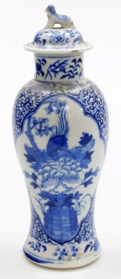 A 19thC Chinese porcelain baluster vase and cover, the lid with dog of fo finial, decorated in blue and white with reserves of a phoenix and a flowering branch, four character Kangxi mark to underside, 27cm high. - 3
