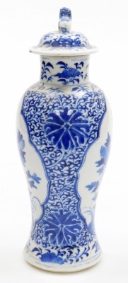 A 19thC Chinese porcelain baluster vase and cover, the lid with dog of fo finial, decorated in blue and white with reserves of a phoenix and a flowering branch, four character Kangxi mark to underside, 27cm high. - 4