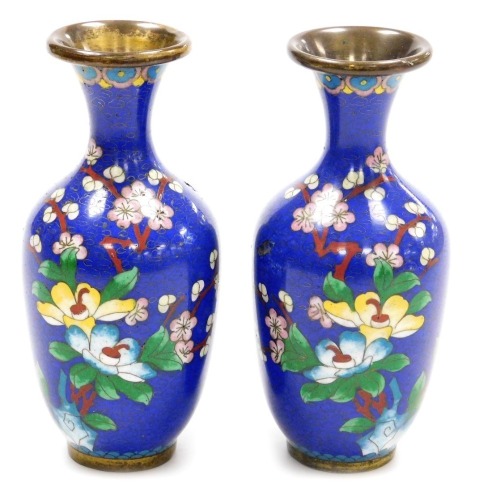 A pair of Chinese cloissone vases, of baluster form with a flared rim, each decorated with birds and flowers on a blue ground, 15cm high. (AF)