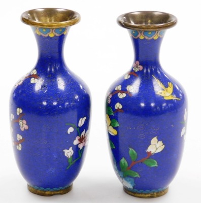 A pair of Chinese cloissone vases, of baluster form with a flared rim, each decorated with birds and flowers on a blue ground, 15cm high. (AF) - 2