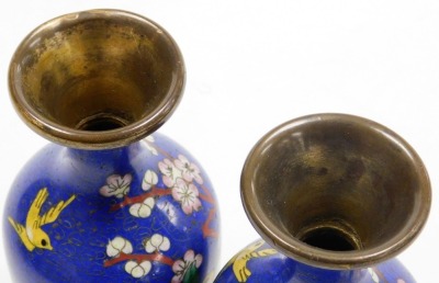 A pair of Chinese cloissone vases, of baluster form with a flared rim, each decorated with birds and flowers on a blue ground, 15cm high. (AF) - 5