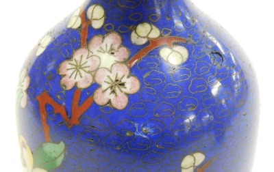 A pair of Chinese cloissone vases, of baluster form with a flared rim, each decorated with birds and flowers on a blue ground, 15cm high. (AF) - 7